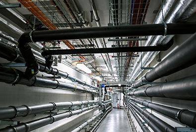 TAP's Hydraulic Design for Commercial systems on Modern Industrial Building with exposed pipes and technical infrastructure designed to perform